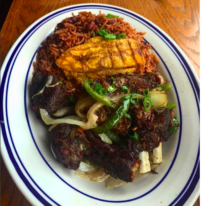 A plate of the Tassot Cabrit, bone-on goat with rice beans and plantains via @grandchampsbk