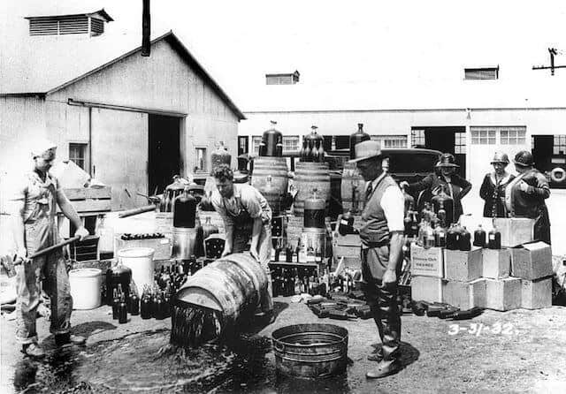 Sheriff deputies dumping illegal booze during Prohibition. Photo via Wikipedia 